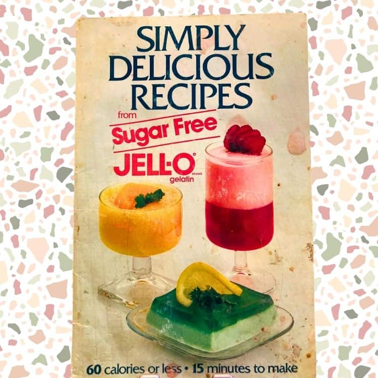 Photo showing the cover of the Simply Delicious Jello Recipes book. It shows 3 different desserts made with Jello in 3 flavors: lime, orange and strawberry. Used to illustrate the Grandparents Day activities post showing a recipe you can make with the grandkids.
