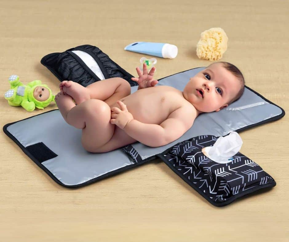 Pictures of a baby lying on a changing pad that also stores diapers and wipes. There are also toys and lotion scattered around the baby. Used for the What does a first-time grandma need? post, diapering section.