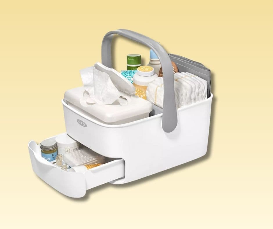 Picture of a white plastic diaper caddy that has diapers, wipes, lotions, and medicine in it. Used for the What does a first-time grandma need? post, diapering section.