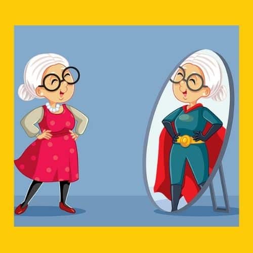 A senior woman in a red jumper and pearls looking into a full-length mirror. Her reflection is dressed in a Superman costume. Both images are smiling. Used to illustrate the post Being a Grandma - How Your Identity May Change.