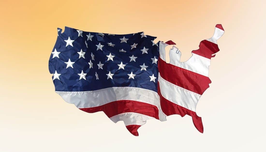 A partial picture of the flag of the United States. The flag is in the shape of an outline of the country. The picture has white stars on a dark blue background on the left. Red and white stripes are located at the bottom and right-hand side. The background is a top-down gradient in gold. Used to illustrate the National Day of Prayer blog post.